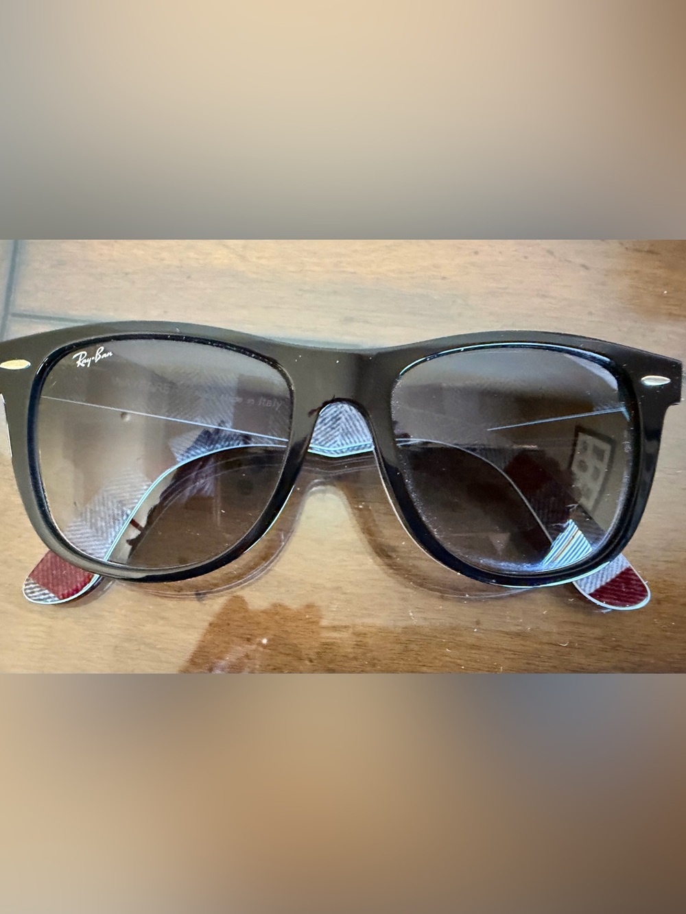 Ray-Ban Classic Black Wayfarer sunglasses with white pinstripe around frame